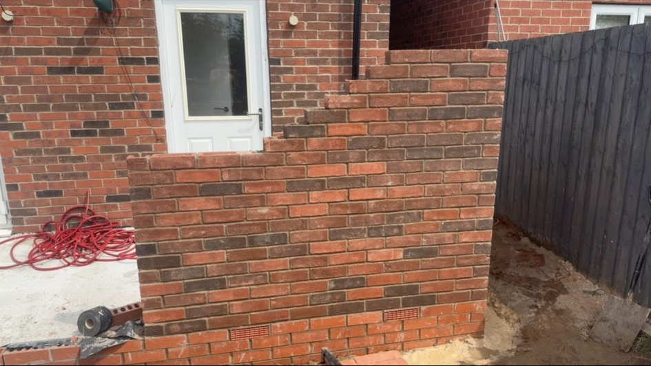 Brick wall in progress in a rear garden